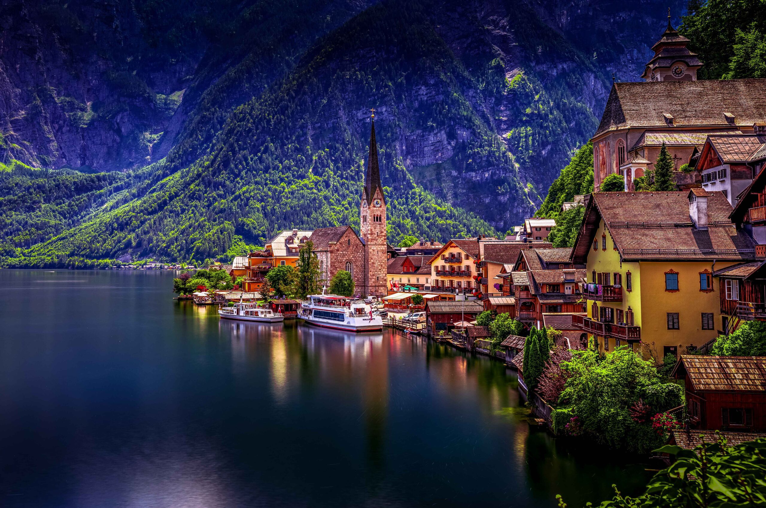 Hallstatt village in Austria with traditional alpine houses along the lake and mountains in the background