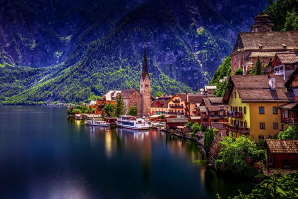 Hallstatt village in Austria with traditional alpine houses along the lake and mountains in the background