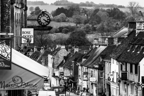 Burford High Street in the Cotswolds, England, with historic stone buildings and boutique shops