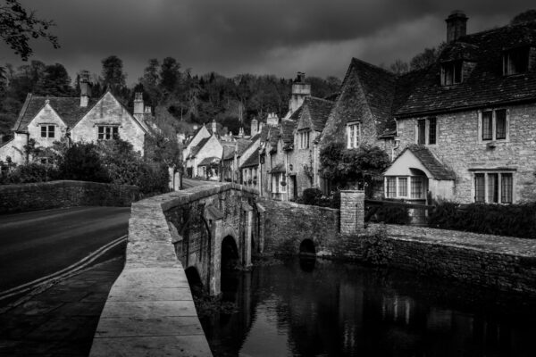 Castle Combe village in the Cotswolds, England, with historic stone cottages and cobbled streets