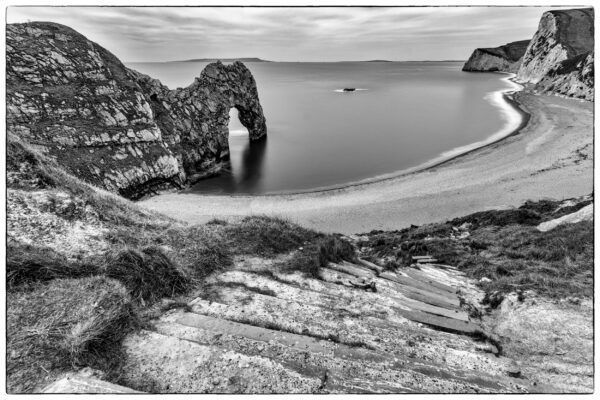 Black and white photograph of Durdle Door limestone arch on the Jurassic Coast in Dorset, England