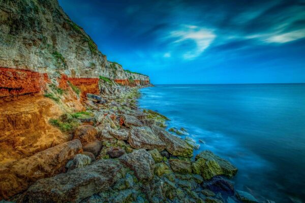 Hunstanton Cliffs in Norfolk, England, with striking red and white chalk layers overlooking the beach