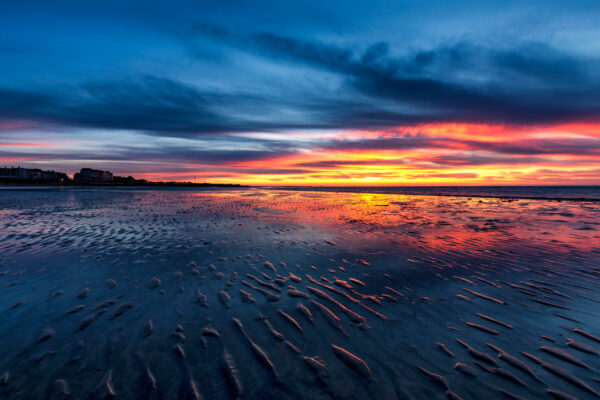 Vibrant sunset over a beach in Kent, England, with dramatic clouds and colourful sky
