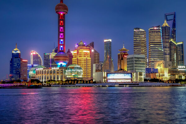 The Bund in Shanghai, China, during blue hour with historic waterfront buildings illuminated along the Huangpu River