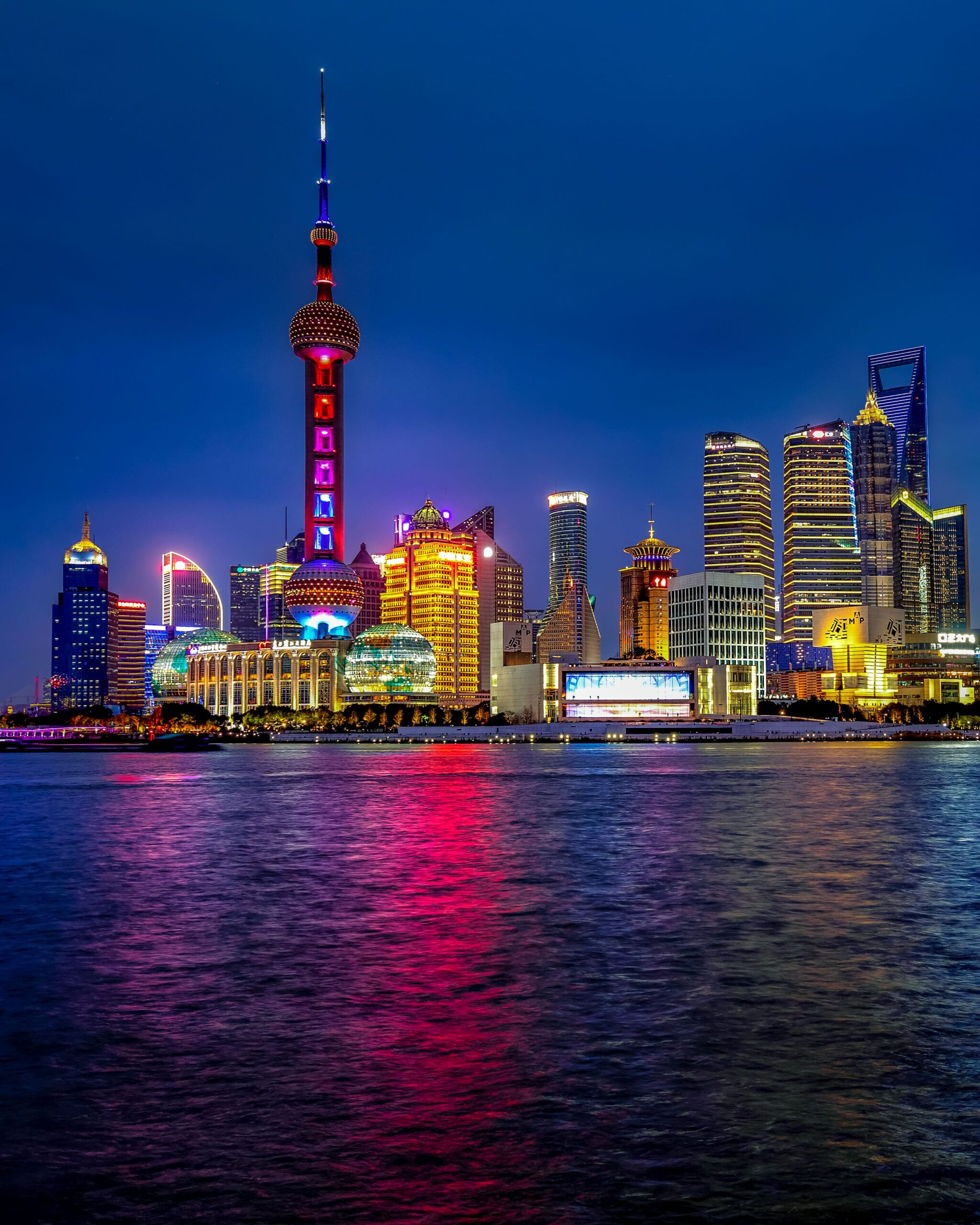 The Bund in Shanghai, China, during blue hour with historic waterfront buildings illuminated along the Huangpu River