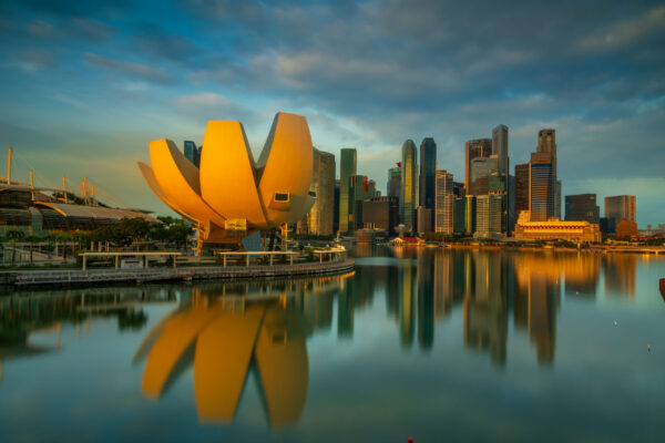 Marina Bay skyline in Singapore at night with illuminated buildings reflected in the water