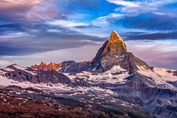 Sunrise over the Matterhorn in Zermatt, Switzerland, with the peak glowing in golden light