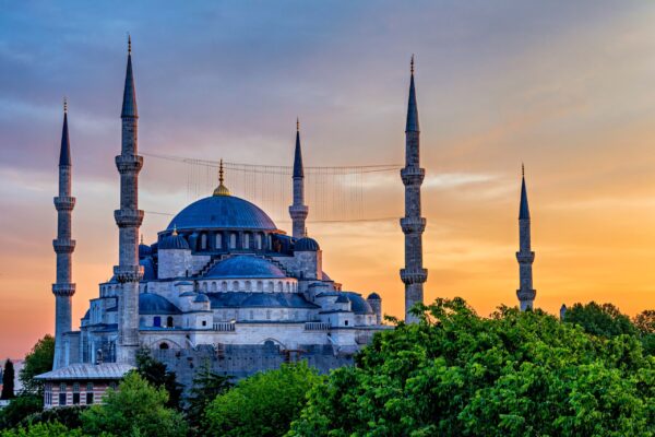 The Blue Mosque in Istanbul, Turkey, at sunset with golden light on its domes and minarets